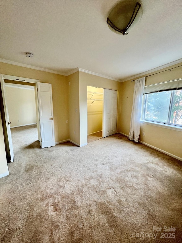 unfurnished bedroom with light colored carpet, a closet, and crown molding