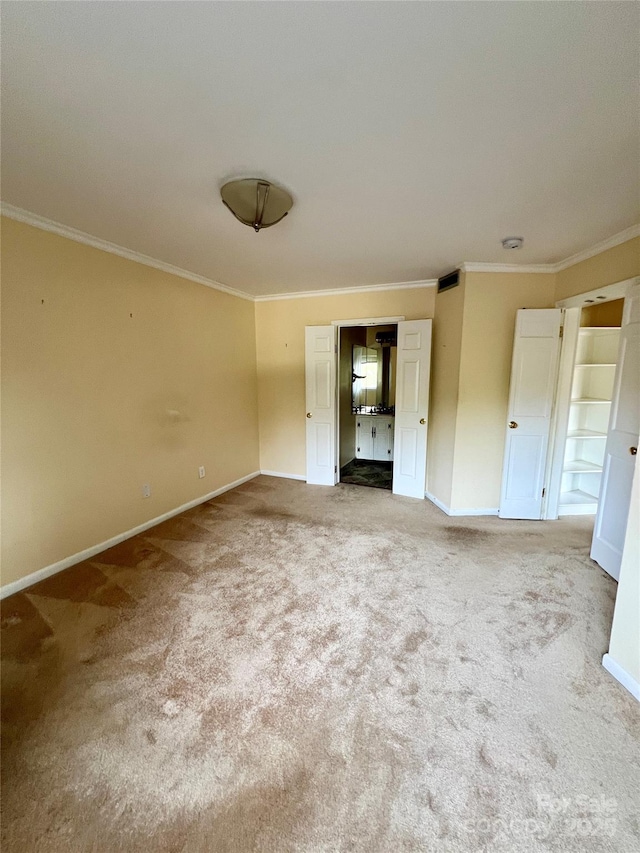 unfurnished bedroom with carpet and crown molding