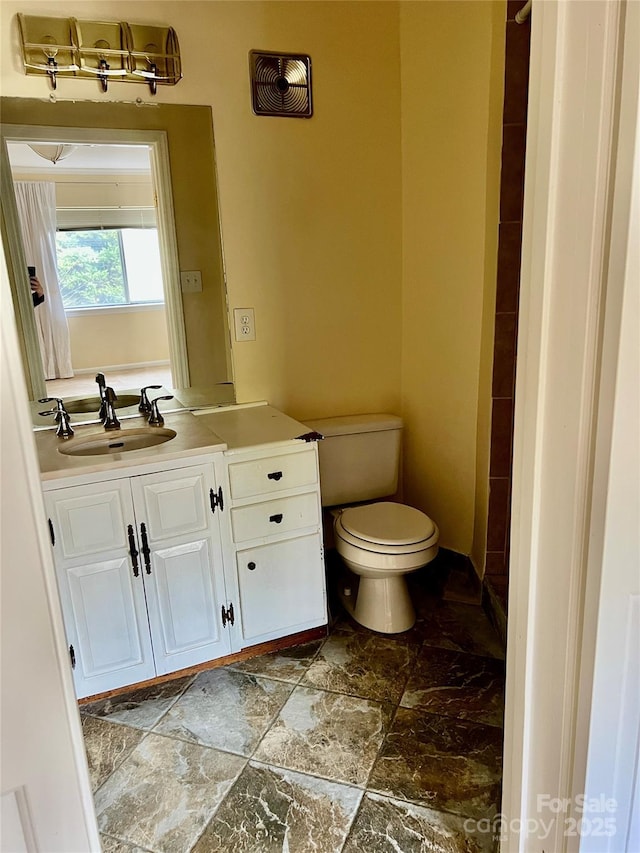 bathroom featuring toilet and vanity