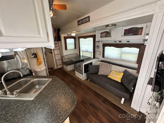 kitchen with white cabinetry, sink, ceiling fan, and dark wood-type flooring