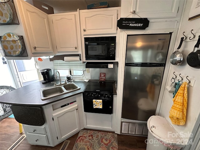 kitchen featuring white cabinets, dark hardwood / wood-style flooring, sink, and black appliances