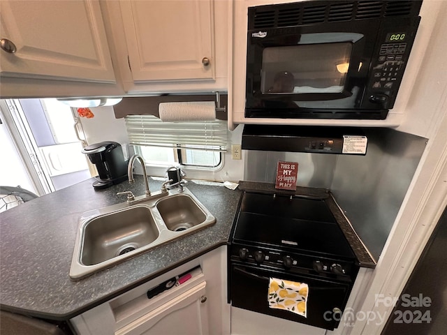 kitchen featuring black appliances, white cabinets, and sink