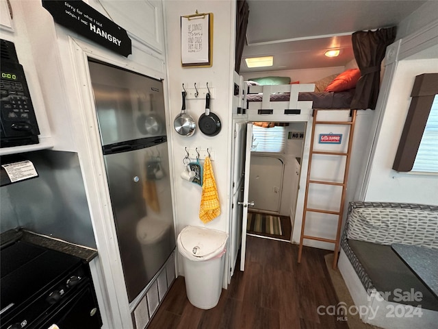 kitchen featuring dark hardwood / wood-style flooring and oven