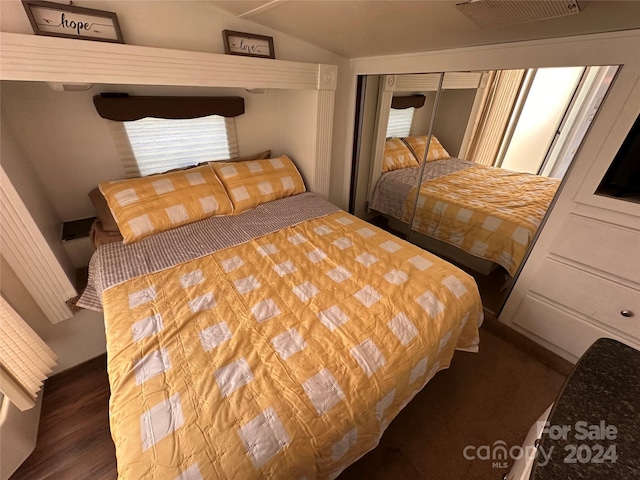 bedroom featuring dark hardwood / wood-style flooring and a closet