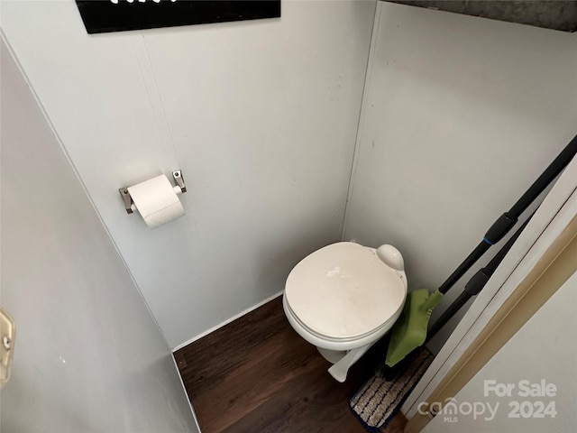 bathroom featuring wood-type flooring and toilet