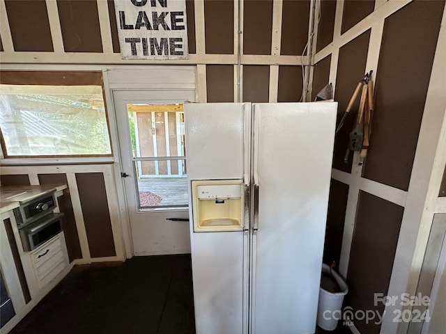 kitchen with white refrigerator with ice dispenser