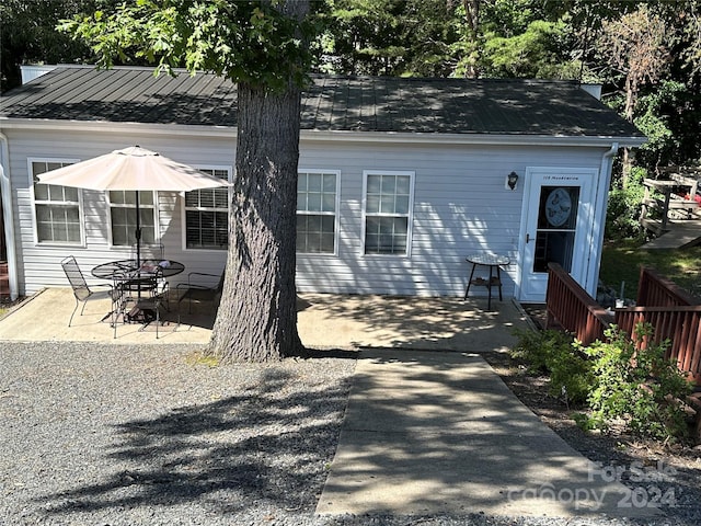 back of property with a patio