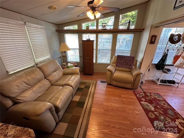 living room with hardwood / wood-style flooring, a wealth of natural light, and ceiling fan