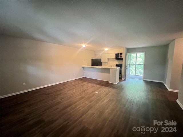 unfurnished living room featuring dark hardwood / wood-style flooring