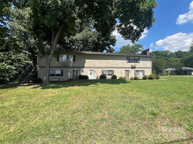 back of house with a yard