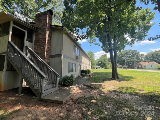 view of home's exterior with a lawn