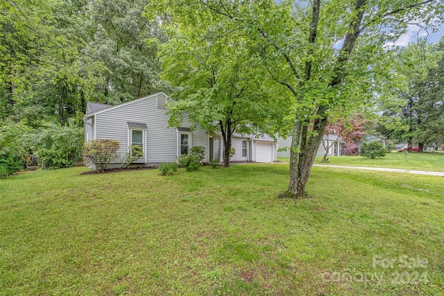 view of front of house with a front yard and a garage