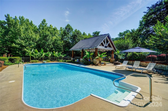 view of swimming pool with a gazebo and a patio