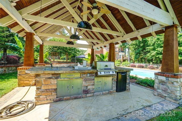 view of patio / terrace with an outdoor kitchen, sink, ceiling fan, a gazebo, and grilling area