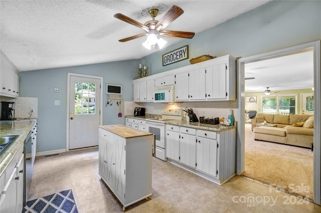 kitchen featuring backsplash, white cabinetry, and white appliances