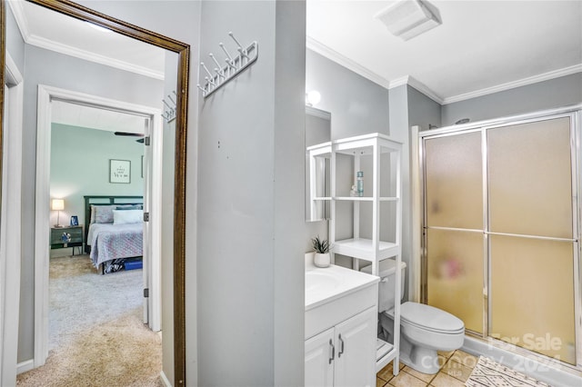 bathroom featuring ornamental molding, toilet, a shower with shower door, and vanity