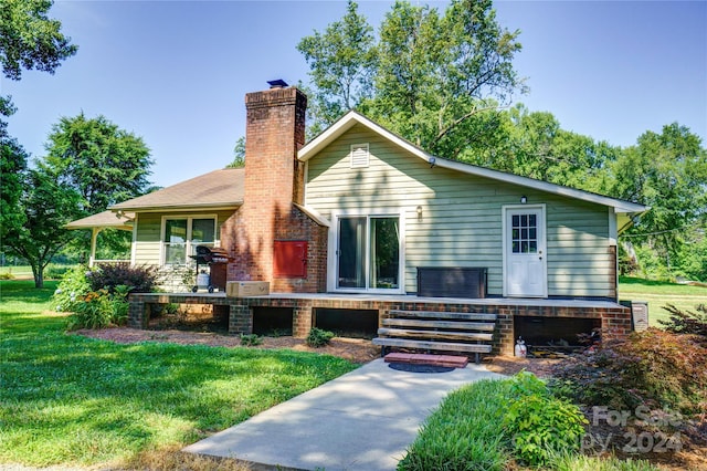 back of house with a lawn