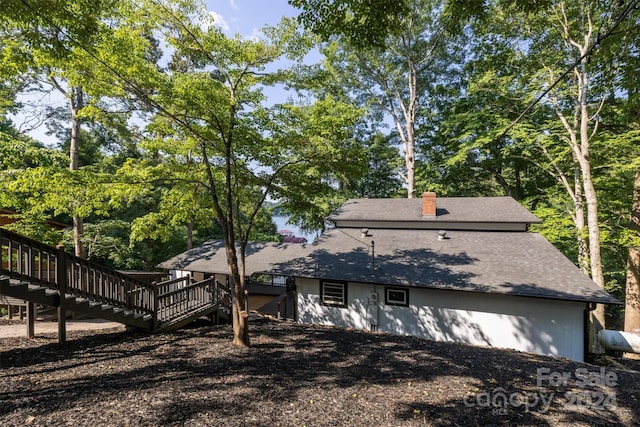 rear view of property featuring a wooden deck