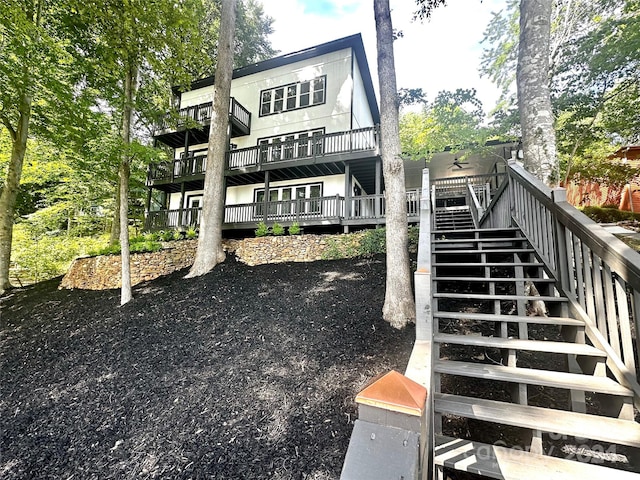 rear view of property featuring a deck