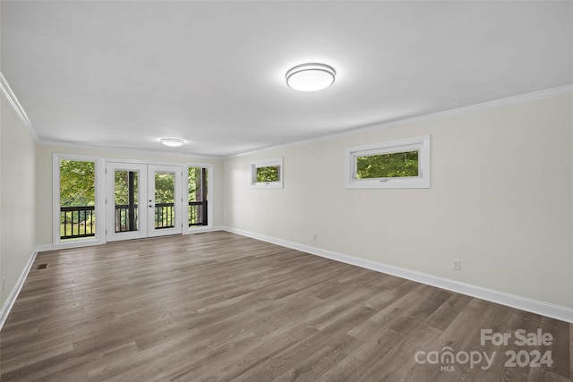 unfurnished room with french doors, crown molding, and hardwood / wood-style floors