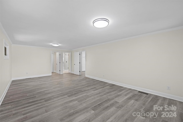 unfurnished room with wood-type flooring and crown molding