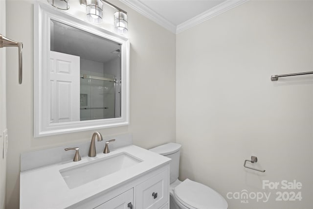 bathroom featuring vanity, toilet, ornamental molding, and walk in shower