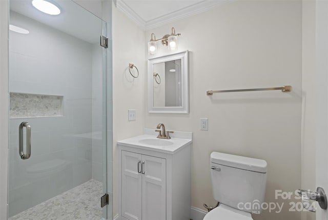 bathroom with an enclosed shower, vanity, toilet, and ornamental molding