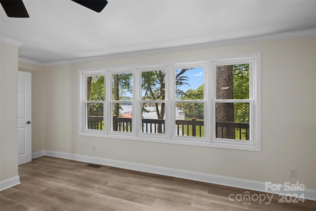 unfurnished room featuring ceiling fan, ornamental molding, and light hardwood / wood-style floors