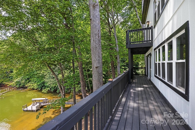 deck with a water view and a boat dock