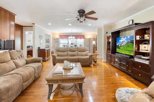 living room featuring crown molding, light hardwood / wood-style flooring, and ceiling fan with notable chandelier