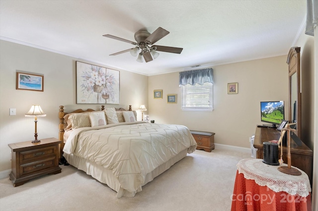 bedroom with ceiling fan, ornamental molding, and light carpet