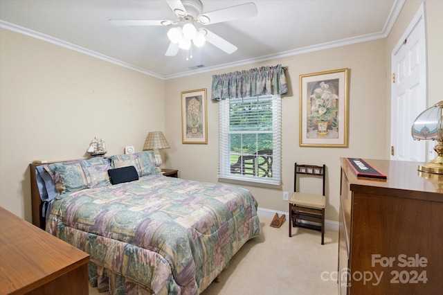 carpeted bedroom featuring ceiling fan and crown molding