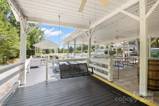 wooden deck featuring ceiling fan