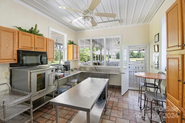 kitchen with wooden ceiling, a wealth of natural light, crown molding, and ceiling fan