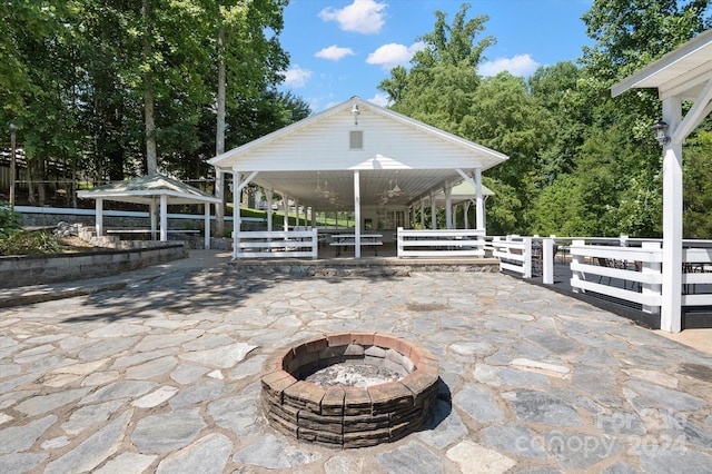 view of patio / terrace with a gazebo and a fire pit