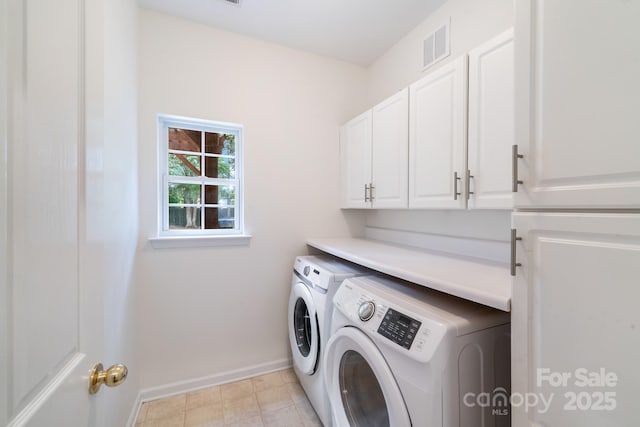 laundry area featuring cabinet space, baseboards, visible vents, and washer and dryer