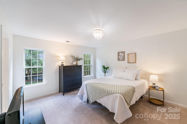 bedroom featuring carpet, baseboards, visible vents, and a chandelier