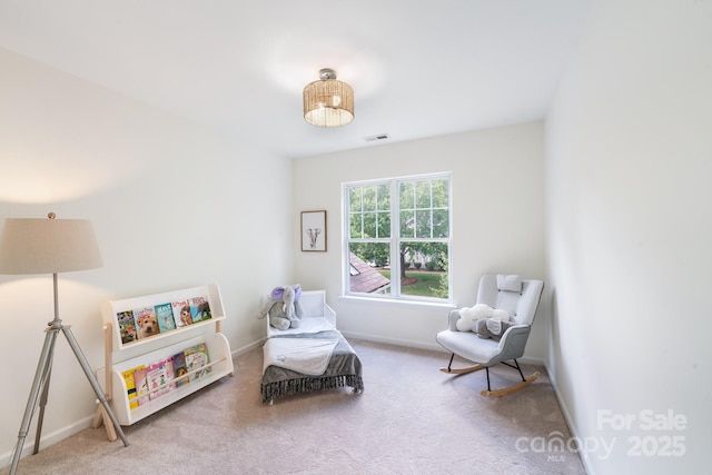 living area with carpet, visible vents, and baseboards