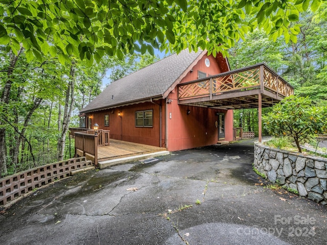 view of side of property featuring a wooden deck