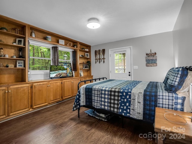 bedroom with dark hardwood / wood-style floors and access to outside