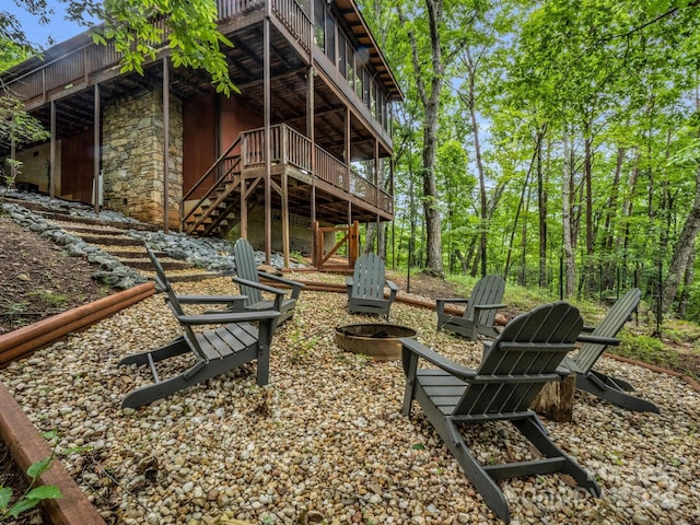 view of yard featuring an outdoor fire pit and a deck