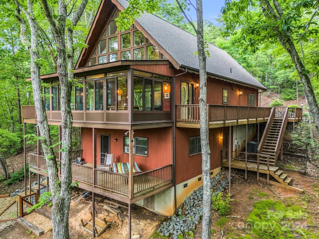 back of property with a sunroom