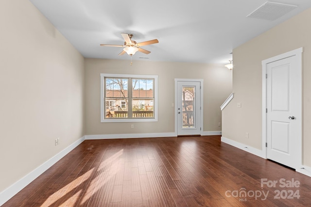 interior space with dark wood-type flooring and ceiling fan