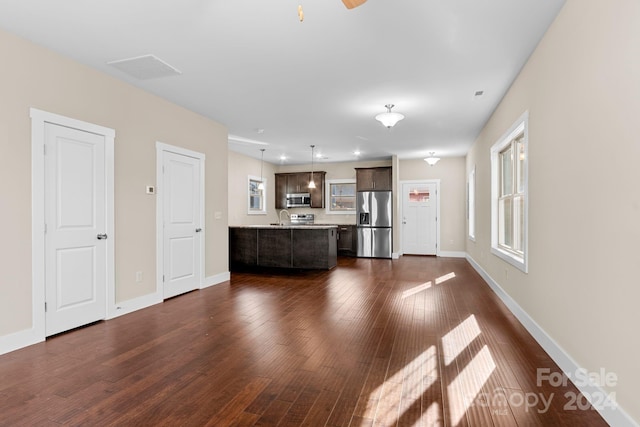 unfurnished living room with sink and dark hardwood / wood-style floors