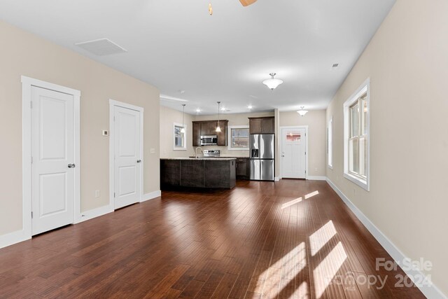 34 Wheeler Rd, Weaverville, NC 28787 - unfurnished living room featuring dark wood-type flooring, baseboards, and a sink