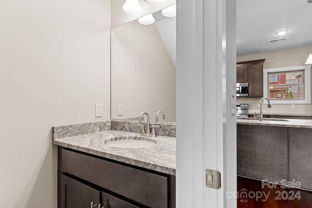 bathroom with vanity and hardwood / wood-style floors