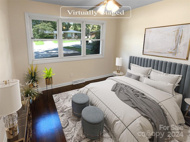 bedroom with ceiling fan and dark wood-type flooring