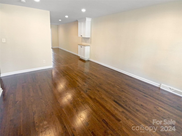 unfurnished living room featuring dark hardwood / wood-style flooring