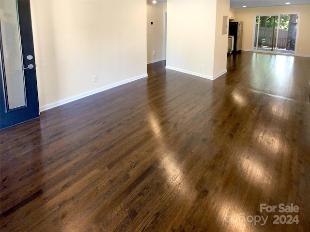 unfurnished room with dark hardwood / wood-style floors