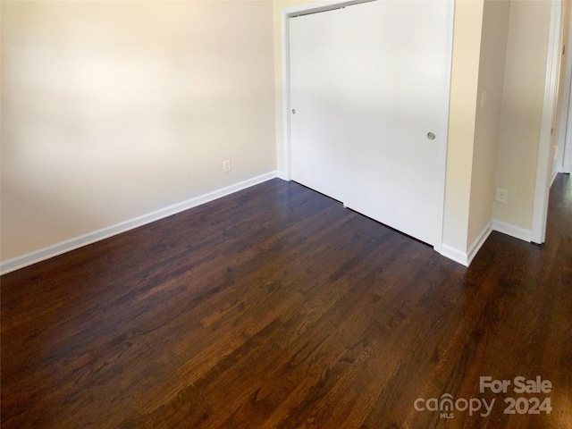 spare room featuring dark hardwood / wood-style flooring